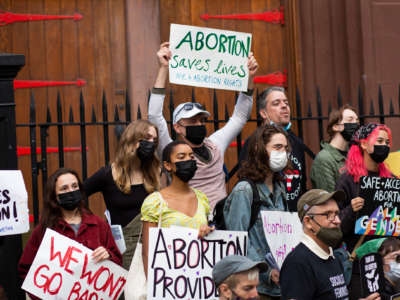 Protesters organized by NYC for Abortion Rights pose for a photo as they demonstrate outside Saint Pauls Roman Catholic Church in the Brooklyn Borough of New York City, on October 9, 2021.