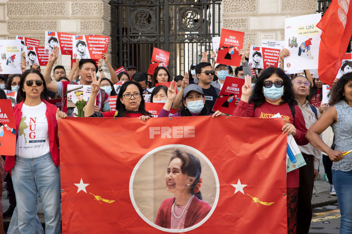 People display signage in support of freeing Aung San Suu Kyi