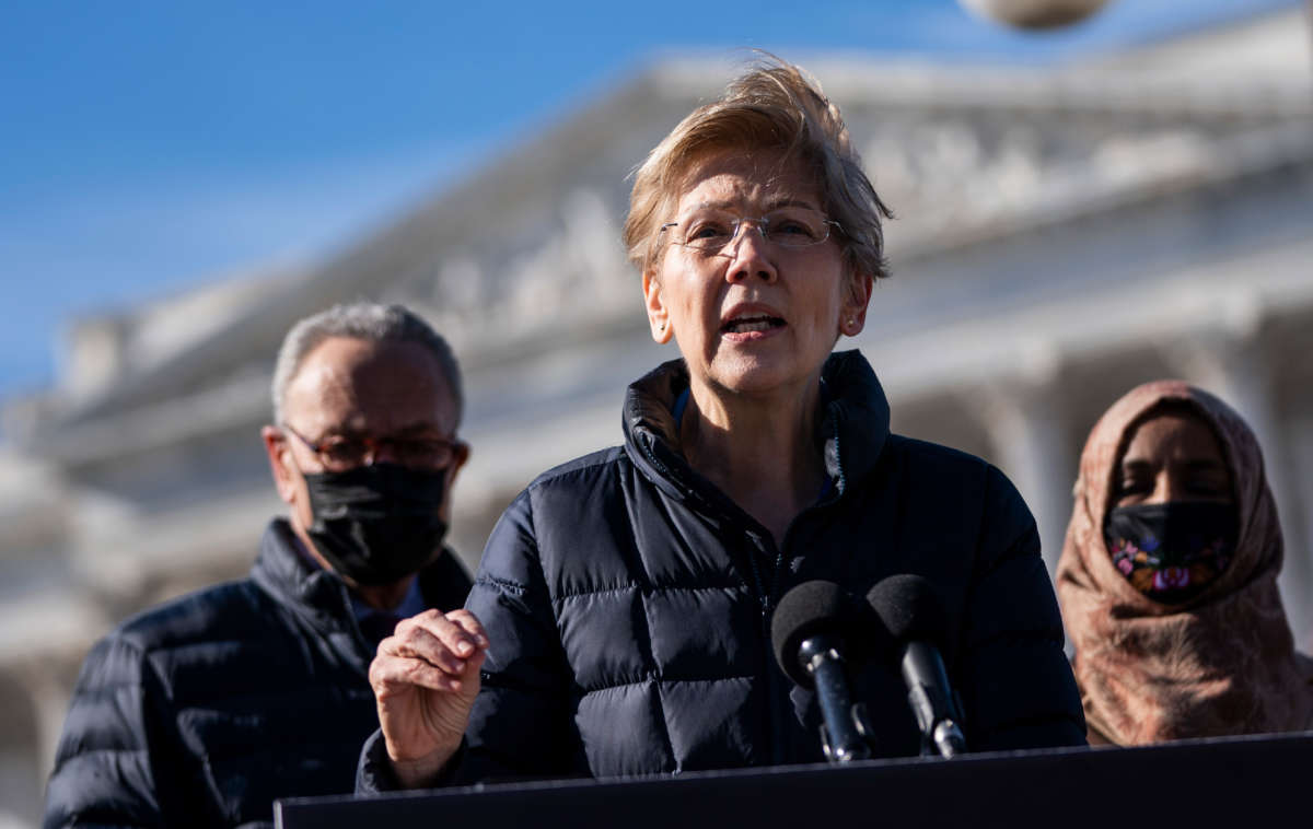 Flanked by Senate Majority Leader Chuck Schumer and Rep. Ilhan Omar, Sen. Elizabeth Warren speaks during a press conference about student debt outside the U.S. Capitol on February 4, 2021, in Washington, D.C.