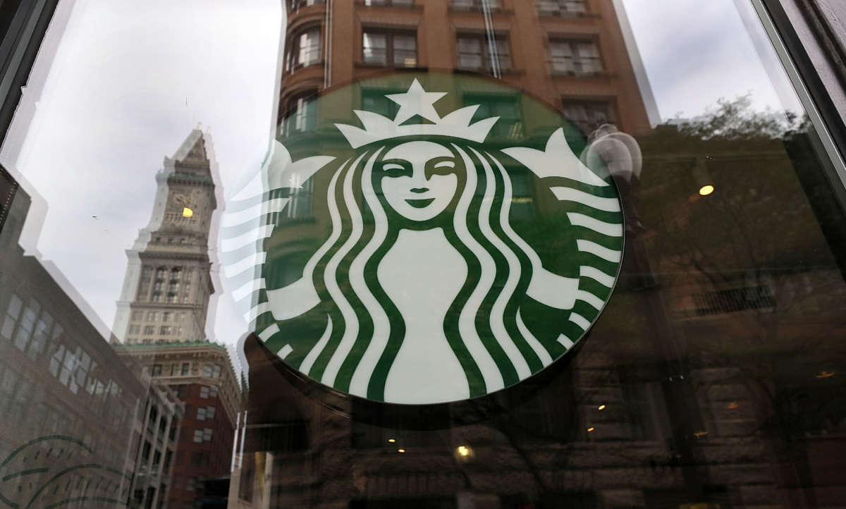 A temporarily closed Starbucks on State Street in Boston and the reflection of Custom House Tower in its window on August 9, 2021.