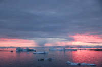 Rain falls on Greenland's glaciers as the sun sets
