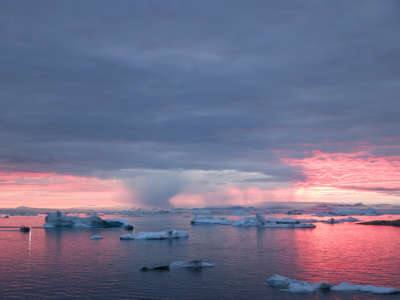 Rain falls on Greenland's glaciers as the sun sets