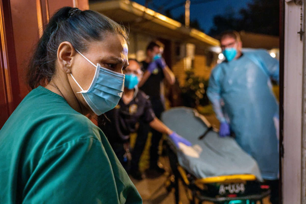 Houston Fire Department paramedics prepare to transport a woman who reported COVID symptoms to a hospital on August 25, 2021, in Houston, Texas.