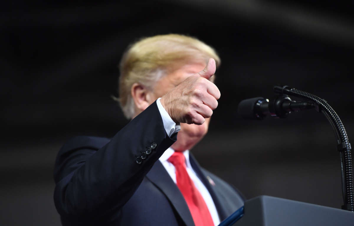 President Donald Trump gives a thumbs up as he addresses a rally in Topeka, Kansas, on October 6, 2018.