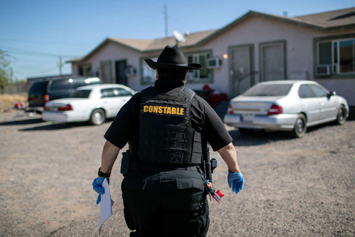 A Maricopa County constable arrives to a home to post an eviction order on October 1, 2020, in Phoenix, Arizona.