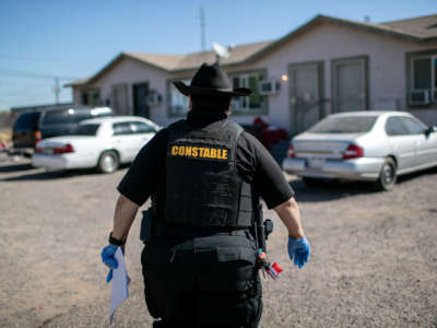 A Maricopa County constable arrives to a home to post an eviction order on October 1, 2020, in Phoenix, Arizona.