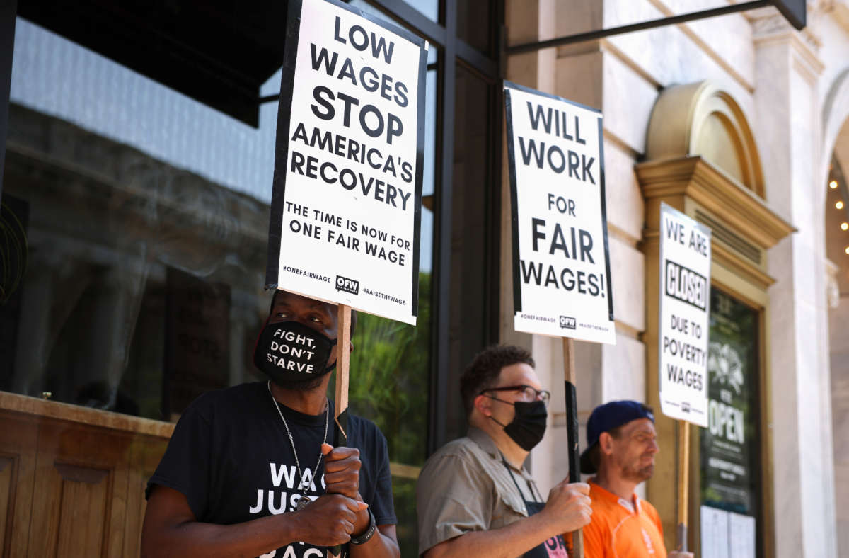 Activists with One Fair Wage participate in a “wage strike" demonstration outside of the Old Ebbitt Grill restaurant on May 26, 2021, in Washington, D.C.