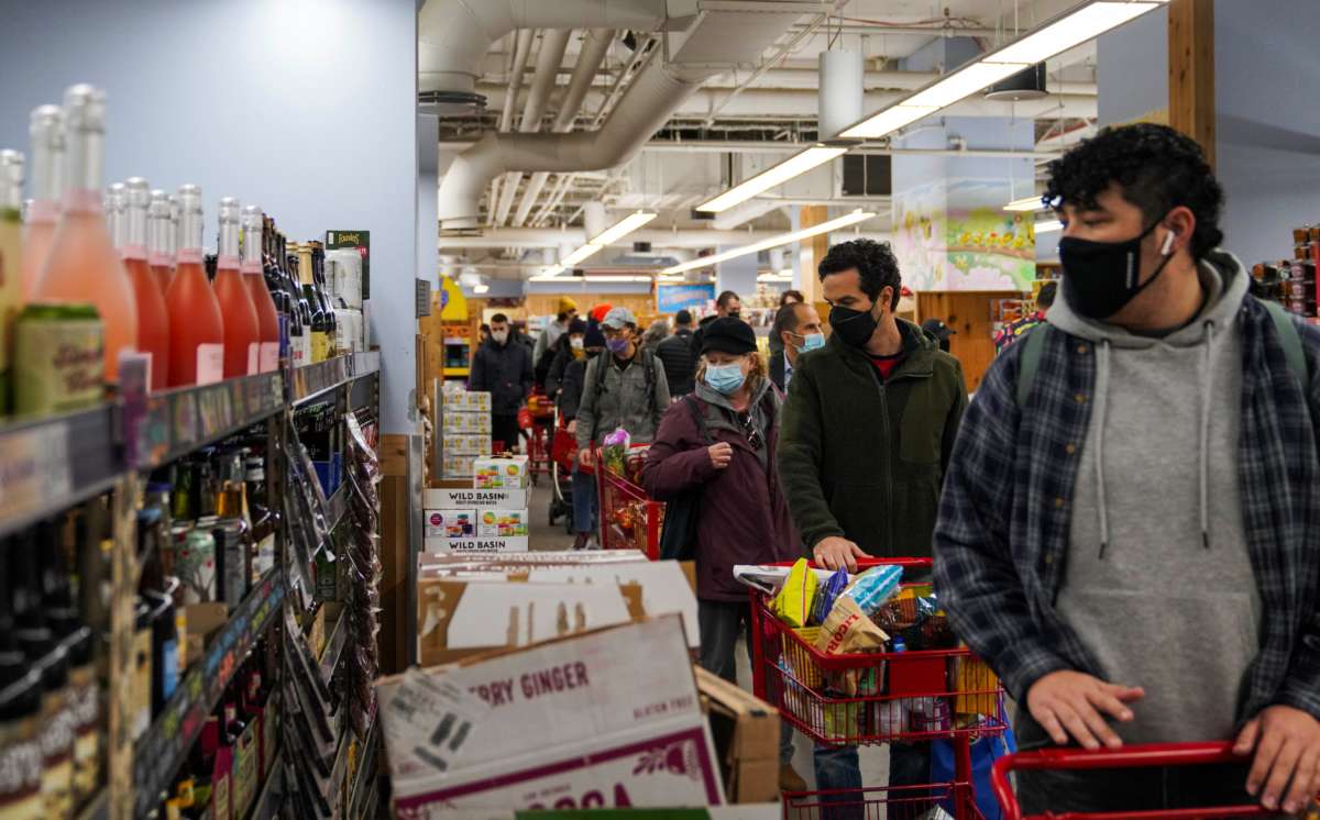 People line up to check out at a grocery store in New York City, on November 14, 2021.