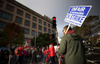A union worker holds a strike sign as he pickets with nurses outside of the Kaiser Permanente San Francisco Medical Center on November 10, 2021, in San Francisco, California.