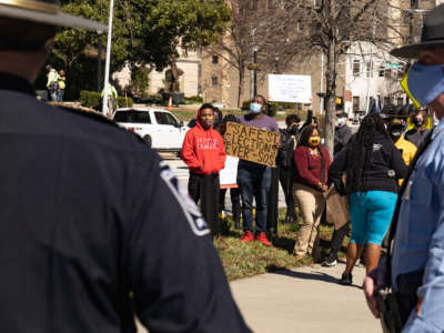 Officers stand between two opposing groups of demonstrators outside of the Georgia Capitol building on March 3, 2021, in Atlanta, Georgia.