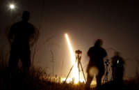 Photographers take pictures of a streak of light trailing off into the night sky as the U.S. military test fires an unarmed intercontinental ballistic missile (ICBM) at Vandenberg Air Force Base, some 130 miles northwest of Los Angeles, California, early on May 3, 2017.