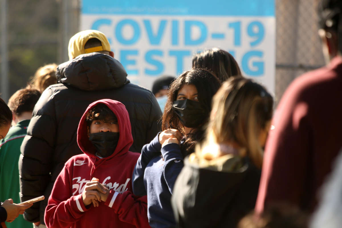 LAUSD students and staff wait in line for a COVID-19 test at a walk-up site at the El Sereno Middle School in the El Sereno neighborhood of Los Angeles, California, on January 4, 2022.