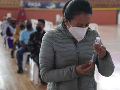 A health worker prepares a dose of the AstraZeneca vaccine as part of the COVID-19 vaccination campaign on January 11, 2022, in Cuenca, Ecuador.