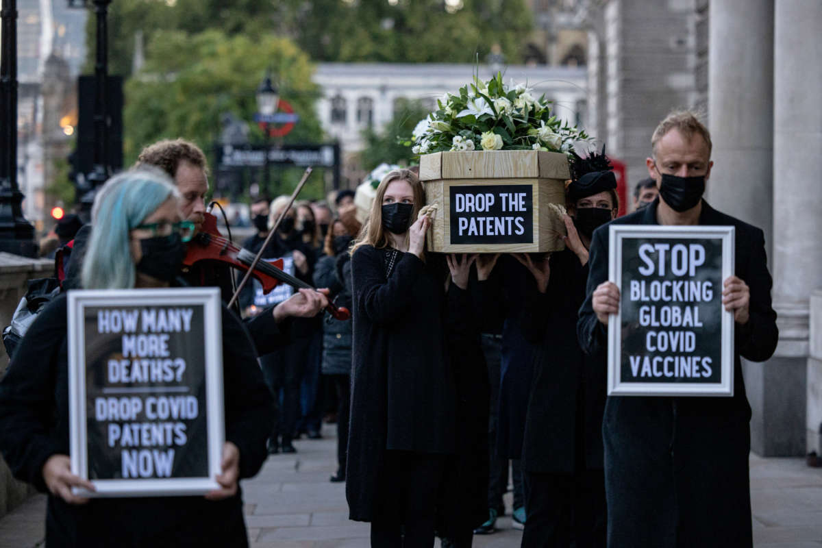 Protesters carry cardboard coffins along Whitehall during a protest against COVID-19 vaccine patents on October 12, 2021, in London, England.