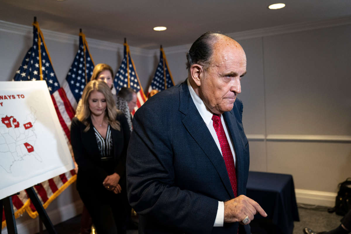 Rudy Giuliani exits after speaking to the press about various lawsuits related to the 2020 election, inside the Republican National Committee headquarters on November 19, 2020, in Washington, D.C.