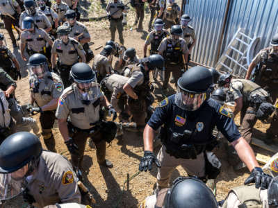 Police in riot gear arrest environmental activists at the Line 3 pipeline pumping station near the Itasca State Park, Minnesota, on June 7, 2021.