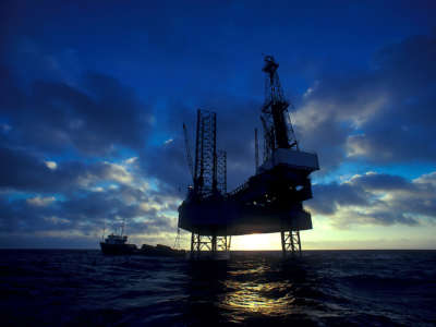 An oil drilling rig at sunset in the Gulf of Mexico.