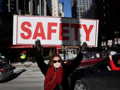 Members of the Chicago Teachers Union and their supporters participate in a car caravan around City Hall to protest against in-person learning in Chicago public schools on January 10, 2022, in Chicago, Illinois.