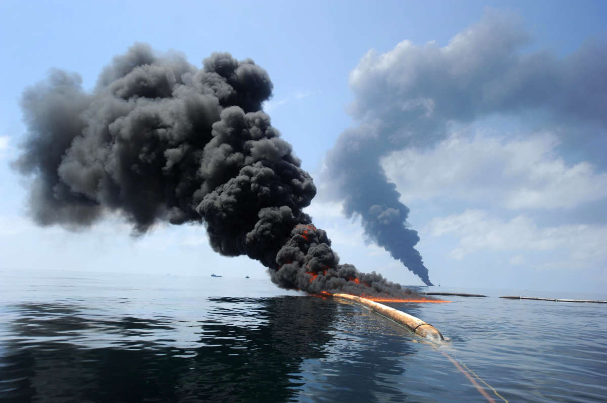 Dark clouds of smoke and fire emerge as oil burns during a controlled fire on May 6, 2010, following the April 20 explosion on Mobile Offshore Drilling Unit Deepwater Horizon in the Gulf of Mexico.
