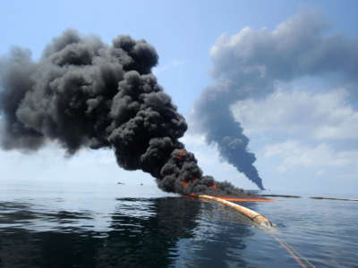 Dark clouds of smoke and fire emerge as oil burns during a controlled fire on May 6, 2010, following the April 20 explosion on Mobile Offshore Drilling Unit Deepwater Horizon in the Gulf of Mexico.
