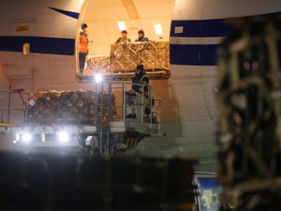 Ground personnel unload weapons, including Javelin anti-tank missiles, and other military hardware delivered on a National Airlines plane by the United States military at Boryspil International Airport near Kyiv on January 25, 2022, in Boryspil, Ukraine.