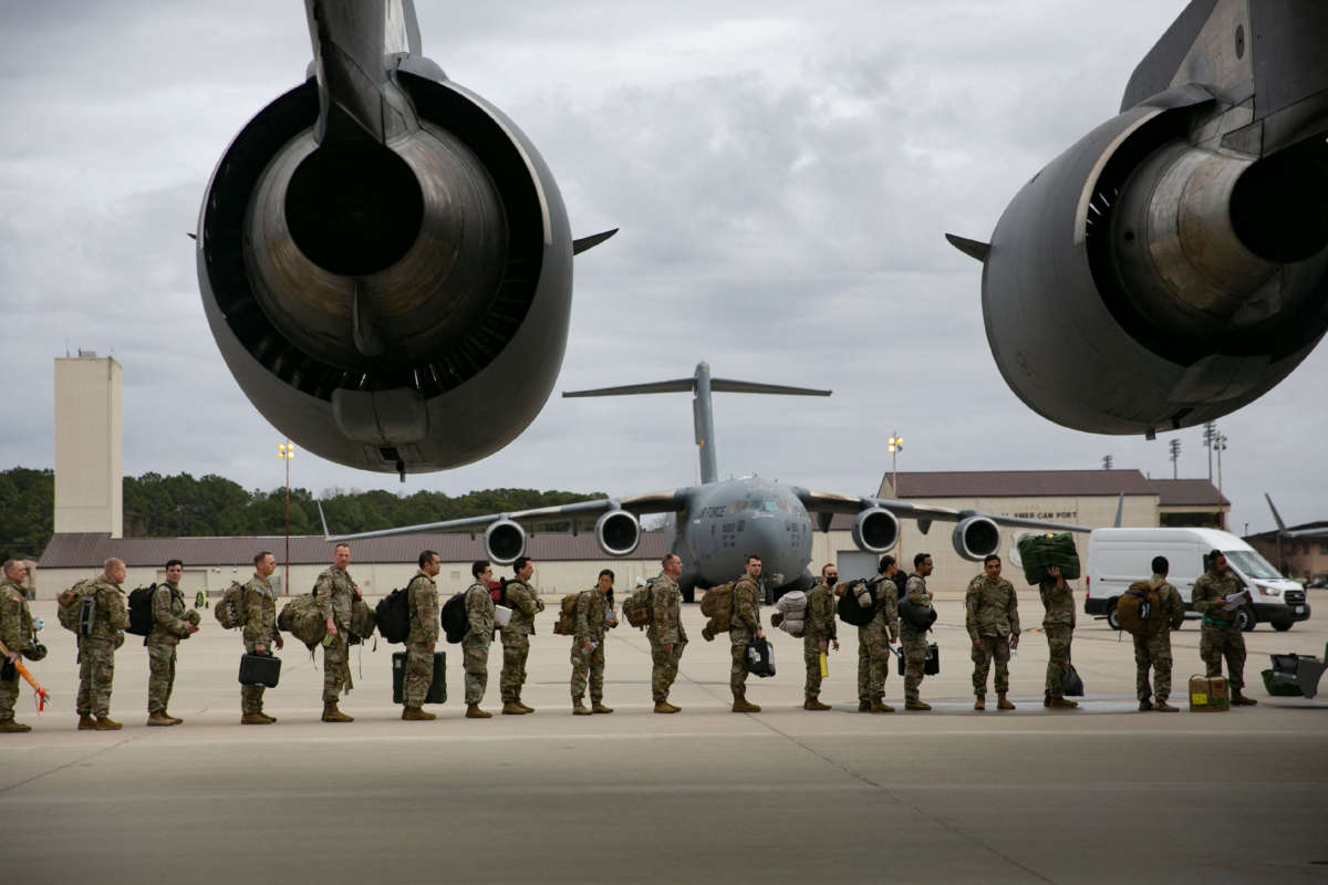 U.S. troops deploy for Europe from Pope Army Airfield at Fort Bragg, North Carolina, on February 3, 2022. The U.S. plans to deploy 3,000 troops to fortify NATO forces in Eastern Europe amid fears Russia could invade Ukraine, the Pentagon said Wednesday.