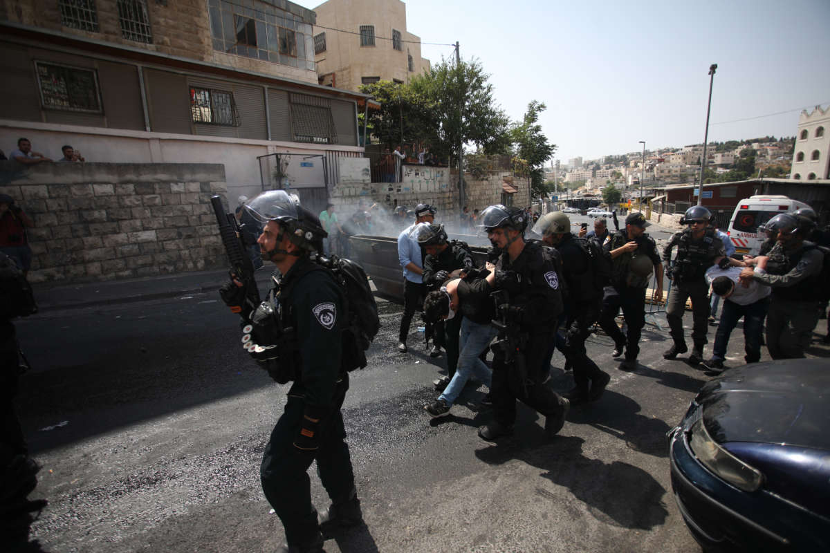 Israeli security forces take Palestinians into custody during a demonstration to protest metal detectors installed by Israeli authorities to Al-Aqsa Mosque Compound, after Palestinians perform Friday prayer on a street at Valley of the Walnuts area in Jerusalem on July 21, 2017.