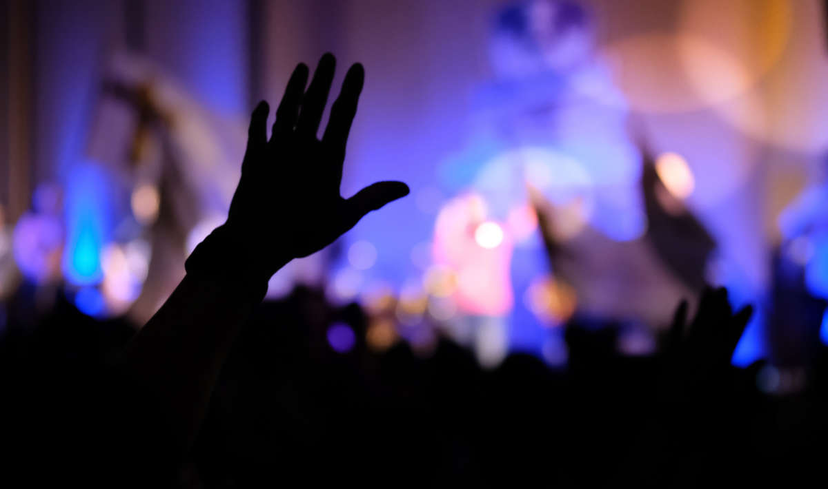 Crowd with hands up during praise / revival