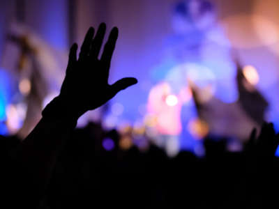 Crowd with hands up during praise / revival