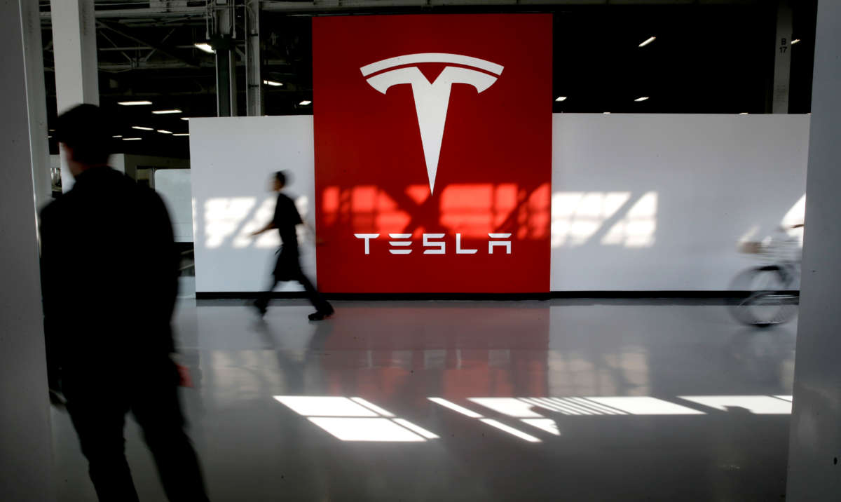 A Tesla logo greets workers heading to the assembly line at Tesla Motors in Fremont, California, on February 19, 2015.