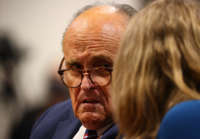 President Donald Trump's personal attorney Rudy Giuliani and Jenna Ellis, a member of the president's legal team, confer during an appearance before the Michigan House Oversight Committee on December 2, 2020, in Lansing, Michigan.