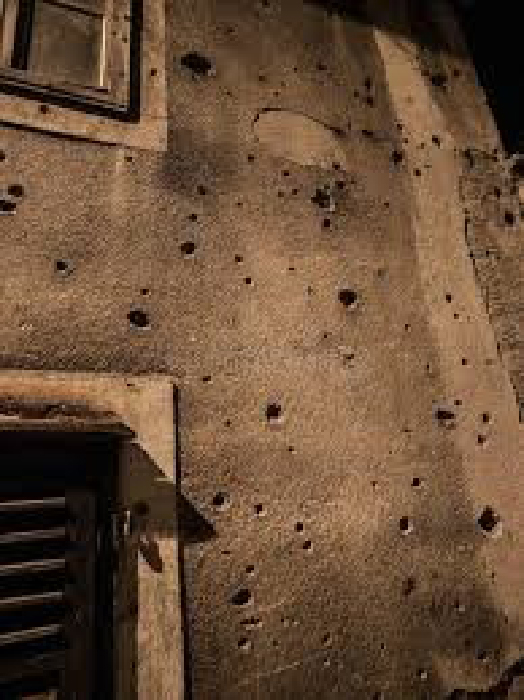 Daniel's family home in Haiti riddled with bullet holes.