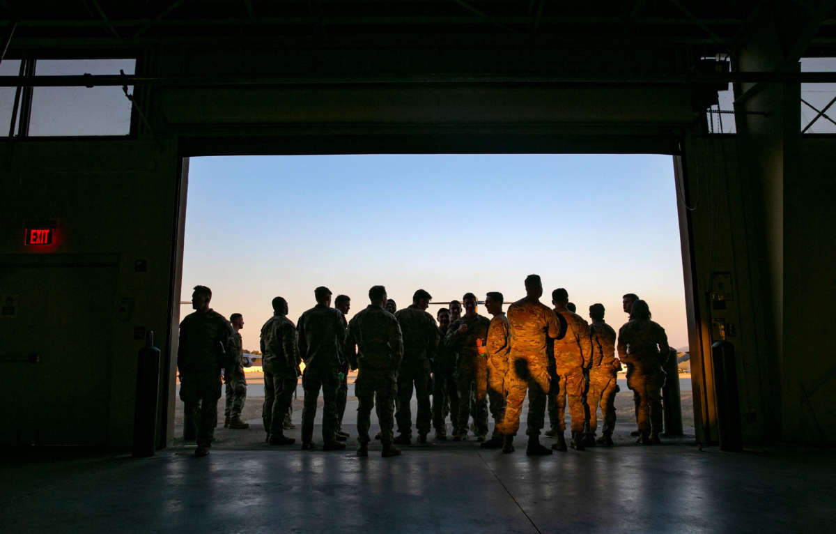 Soldiers of the 82nd Airborne Division look out at the airfield before deploying to Europe on February 14, 2021, in Fort Bragg, North Carolina.