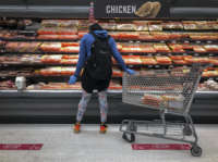 A woman shops in the chicken and meat section at a grocery store on April 28, 2020, in Washington, D.C.