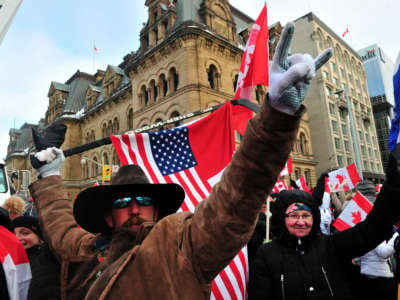 Supporters and truckers front the Parliament Hill during a protest in downtown of Ottawa, Canada, on February 12, 2022.