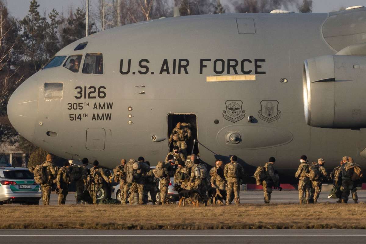 U.S. soldiers disembark from a C-17 Globemaster cargo plane on the tarmac of Rzeszow-Jasionka Airport, south eastern Poland, on February 16, 2022. The soldiers are part of a deployment of several thousand sent to bolster NATO's eastern flank in response to tensions with Russia.