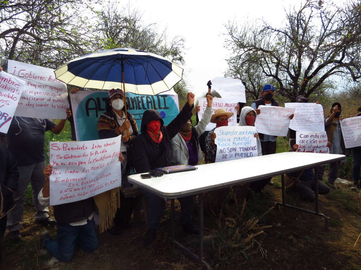 United People of the Cholulteca Region hold a press conference in the rain on February 15, 2022, after they were violently evicted from their community center earlier that day.