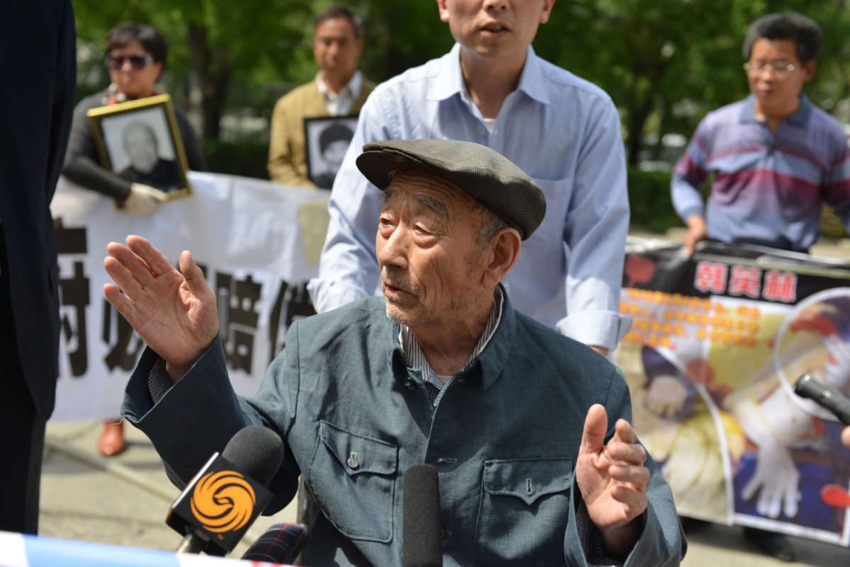 This picture taken on May 13, 2013, shows 89-year-old Zhang Shijie, a Chinese man who says he was forced to perform hard labor in Japan during World War II, speaking to the media before he and other protesters hand over their demands to the Japan side outside the Japan embassy in Beijing.