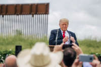 Former President Donald Trump pulls out his notes before speaking during a tour to an unfinished section of the border wall on June 30, 2021, in Pharr, Texas.