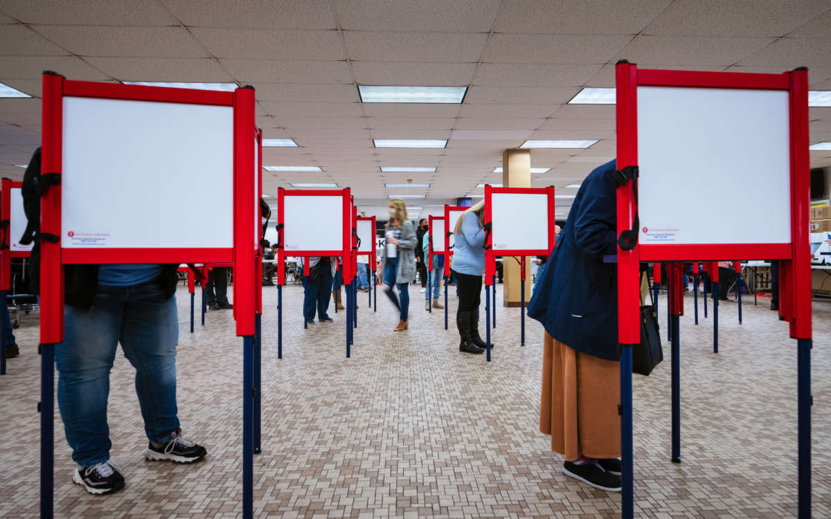 Voters stand at ballot boxes and cast their votes at Fairdale High School on November 3, 2020, in Louisville, Kentucky.