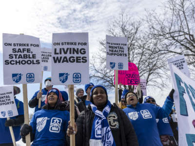Minneapolis school teachers hold placards during the strike in front of the Justice Page Middle school in Minneapolis, Minnesota, on March 8, 2022.