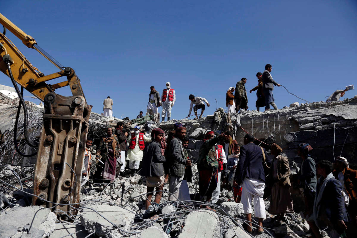 People search for survivors at a prison destroyed in an airstrike in Saada, Yemen, on January 22, 2022.