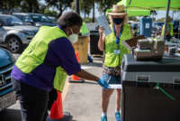 Workers drop ballots into a secure box at a ballot drop-off location in Austin, Texas, on October 13, 2020.