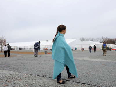 An Afghan girl looks on at temporary housing in Liberty Village on December 2, 2021, in Joint Base McGuire-Dix-Lakehurst, New Jersey.