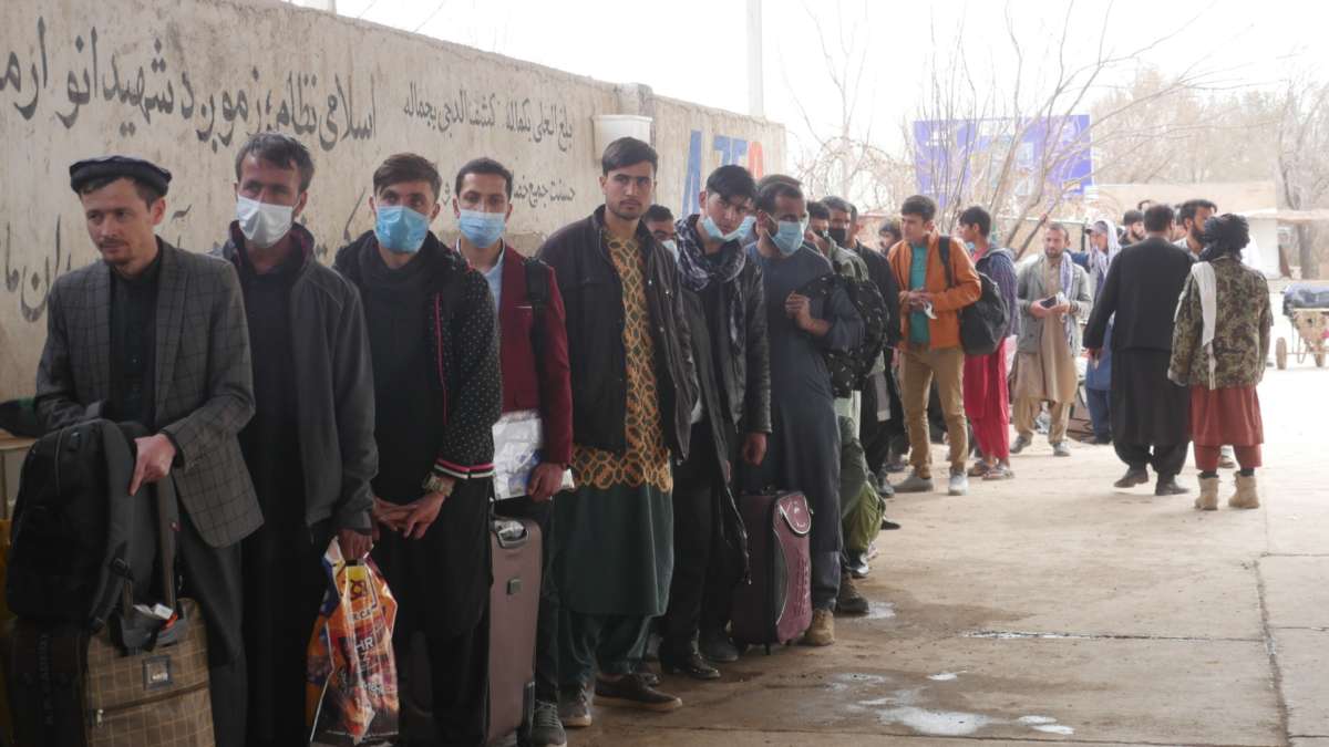 Afghans stand in line to leave the country