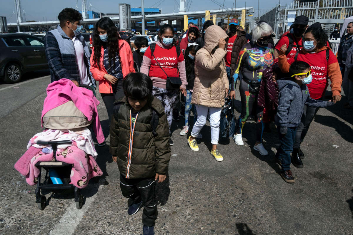 Asylum seekers walk back after been rejected at the border during a protest against Title 42 policy on the Mexican side of the San Ysidro crossing port in Tijuana, Baja California state, Mexico, on March 21, 2022.