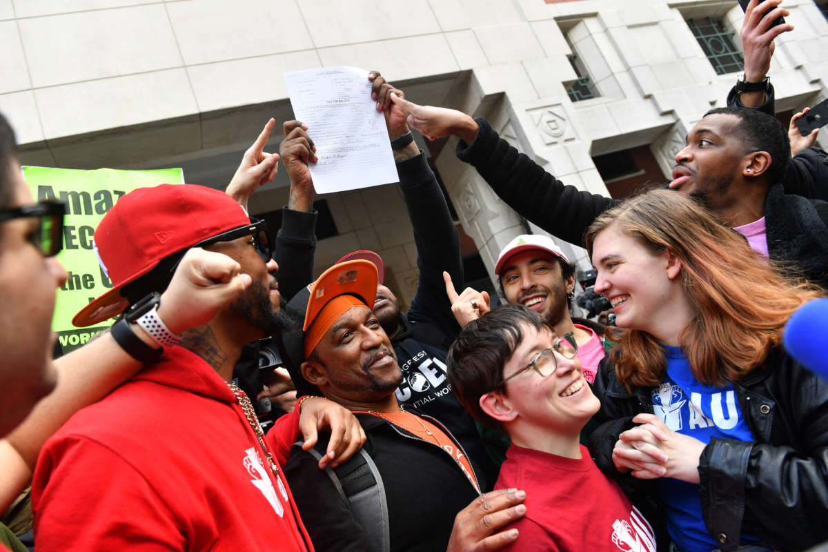 Union organizer Christian Smalls (left) celebrates with Amazon workers following the April 1, 2022, vote for the unionization of the Amazon Staten Island warehouse in New York.