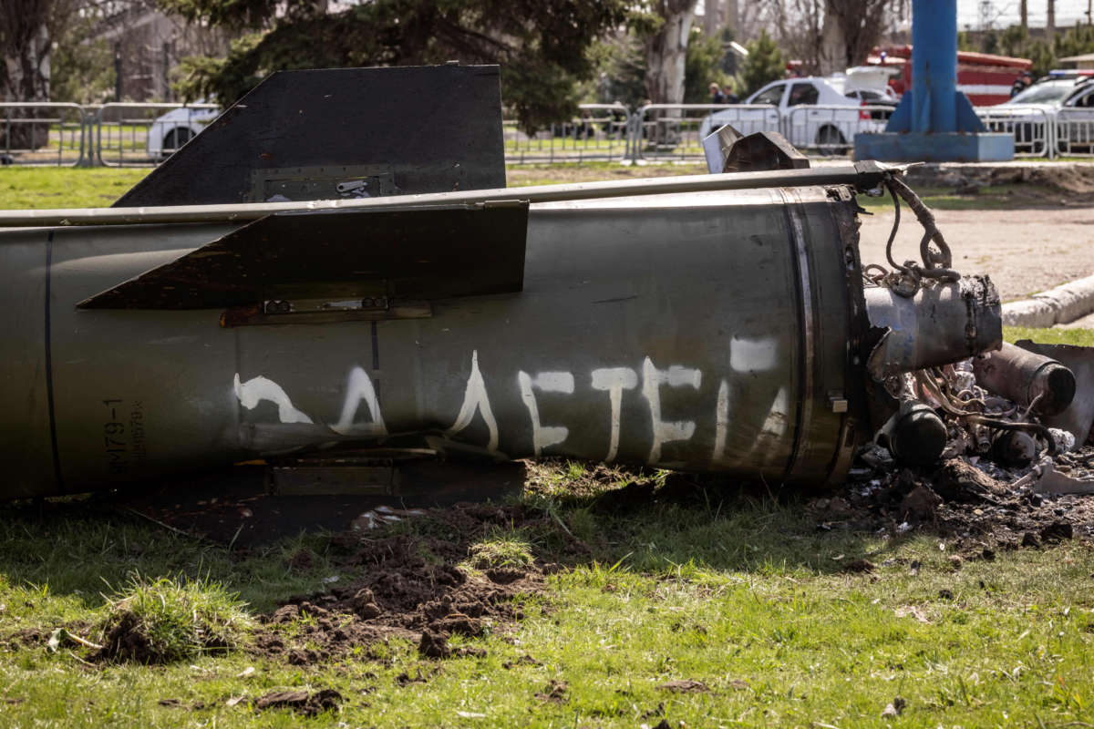 The remains of a large rocket with the words 'for our children' in Russian is pictured next to the main building of a train station in Kramatorsk, eastern Ukraine, that was being used for civilian evacuations, that was hit by a rocket attack on April 8, 2022.