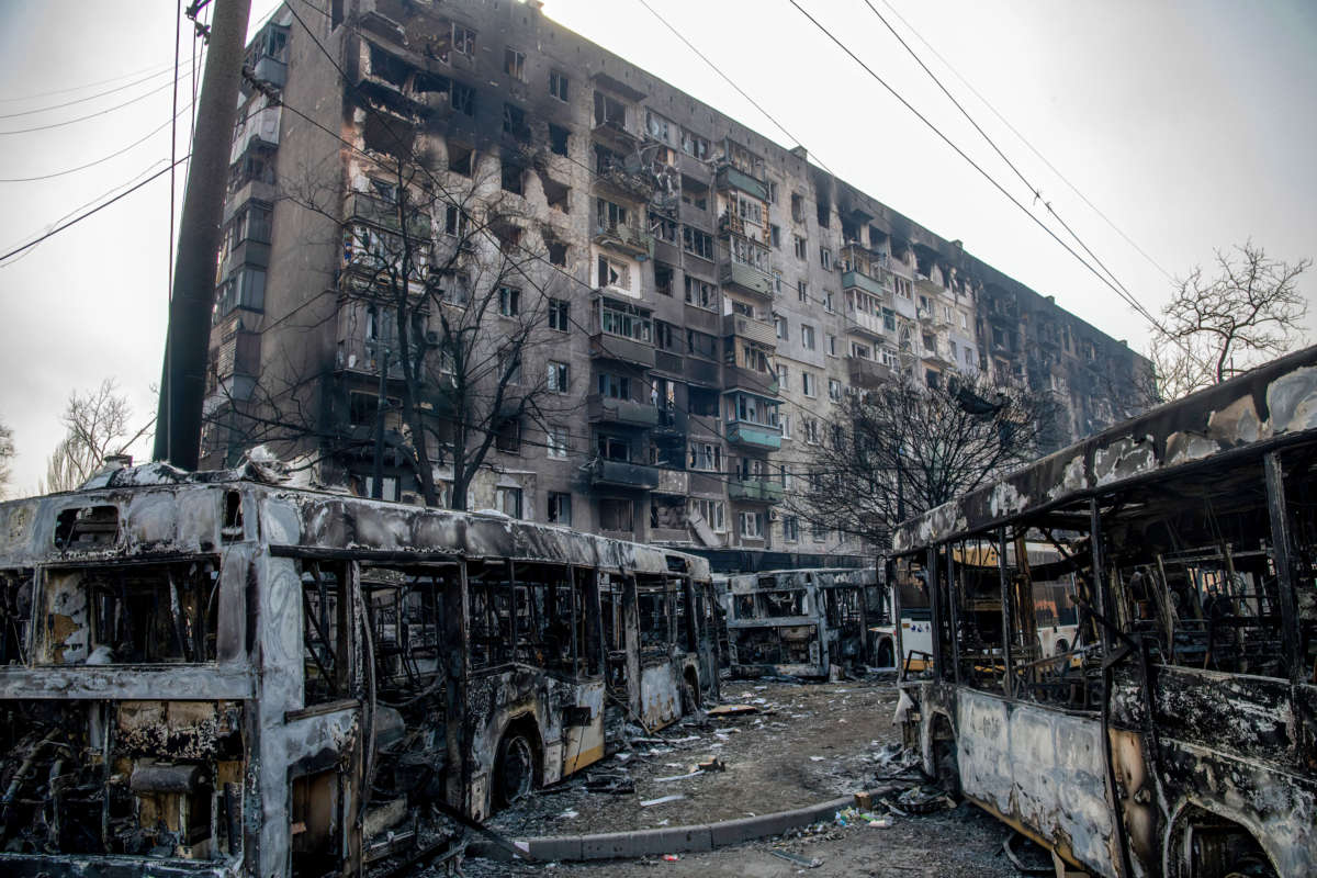 A line of buses placed by Ukrainian Azov Battalion defenders to impede the advance of Russian / pro-Russian forces as they fight deeper into the city is seen on March 23, 2022, in Mariupol, Ukraine.