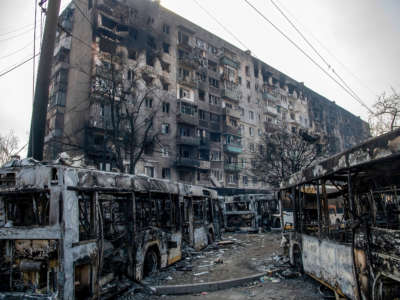 A line of buses placed by Ukrainian Azov Battalion defenders to impede the advance of Russian / pro-Russian forces as they fight deeper into the city is seen on March 23, 2022, in Mariupol, Ukraine.